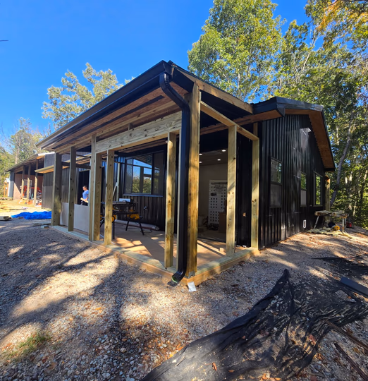 Porch framing on a black metal barndominium